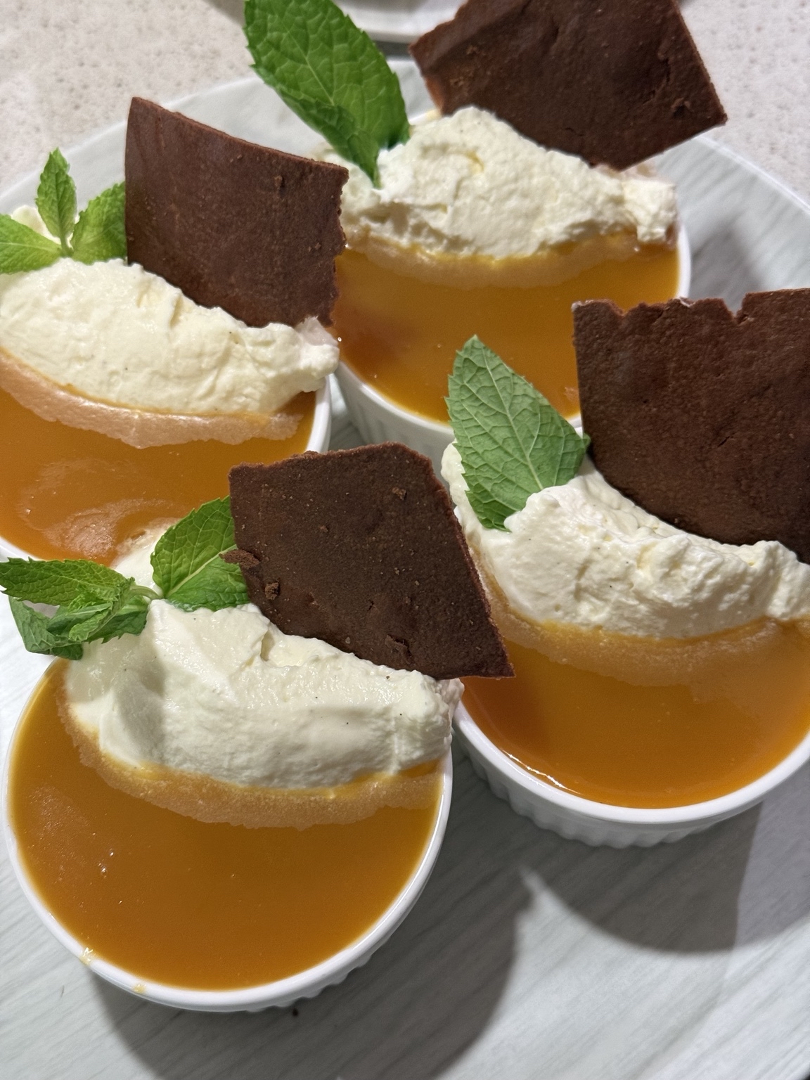 Individual desserts with whipped cream, mint and chocolate